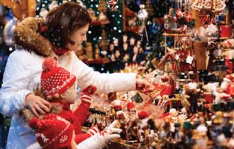 A family looking at a stall at the Beamish Hall Hotel Christmas Fair