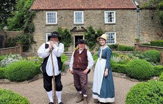 Pockerley at Beamish with three people dressed in period dress