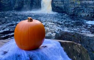 A pumpkin on a rock at High Force Waterfall
