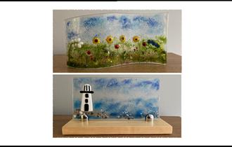 two examples of fused glasswork.  One, a coastal picture with lighthouse and one a field of flowers, including sunflowers