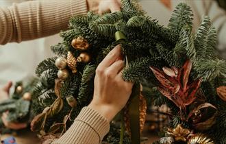 Someone making a Christmas Wreath