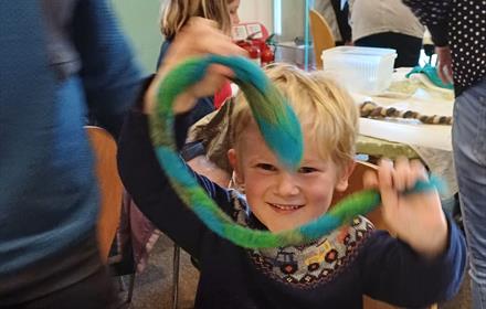 Boy holding felt snake