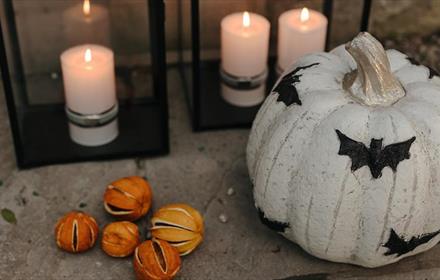A decorated pumpkin and candles