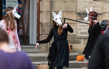 Image of actors dressed as wolves.