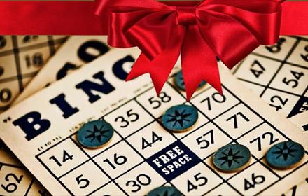Bingo cards with a festive red ribbon topping the poster.