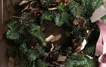 A Christmas Wreath with a pink ribbon