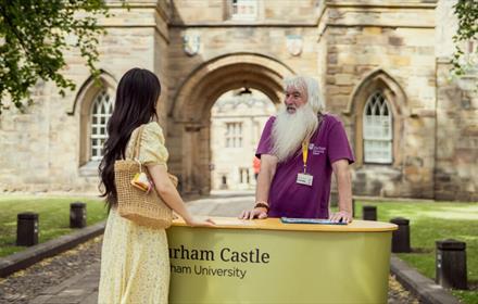 A castle guide and a visitor at Durham Castle