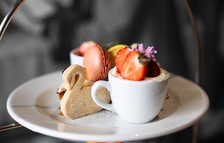An example of the afternoon tea Café Bowes makes featuring macaroons, scones and swan style biscuit.
