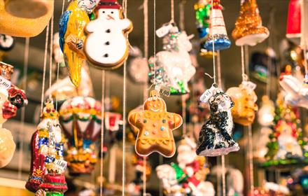 Christmas decorations hanging from Christmas market stall