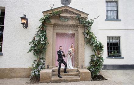 Wedding couple on the doorstep of the hotel