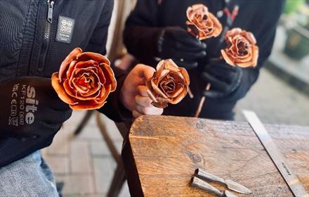 Copper Rose Workshops - people holding copper roses at South Causey Inn.
