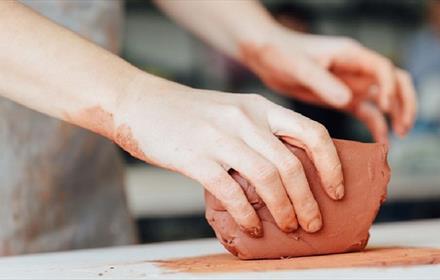 someone working with a block of clay