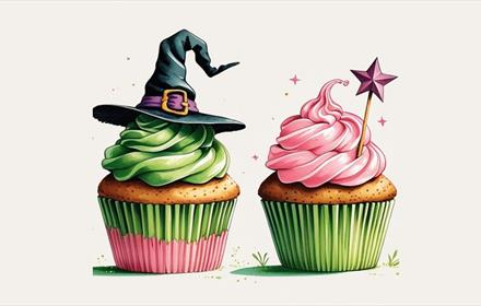 Cupcakes decorated in pink and green with a witch's hat and wand