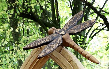 Carved wooden sculpture depicting a Dragonfly