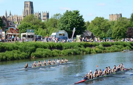 Teams of eight racing at Durham Regatta on a beautiful sunny day against the backdrop of Durham Cathedral and Castle.