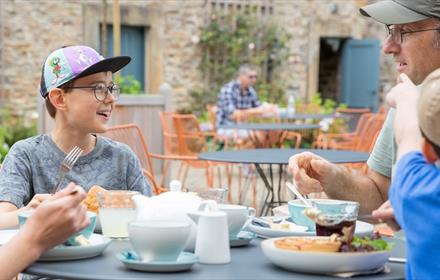 Father’s Day at Auckland Palace. A father and his two sons enjoying 'Gentleman's Afternoon Tea'.