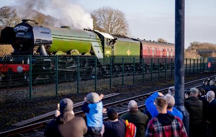 The Flying Scotsman arriving at Locomotion with crowds of people watching  by Charlotte Graham