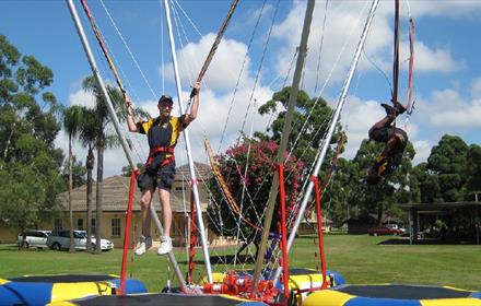people on bungee trampolines at Fun in the Park event.