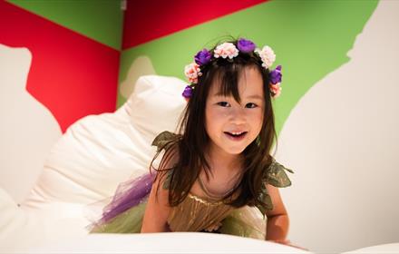 A little girl wearing a fairy outfit playing on squishees in Pippa Hale Pet Project