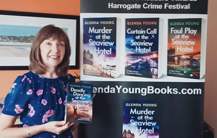 Glenda Young holding her new book Deadly Dancing at the Seaview Hotel.