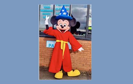 Someone dressed as a Mickey Mouse Wizard