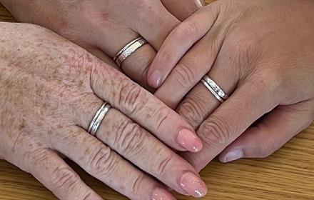 Hands displaying silver stacking rings