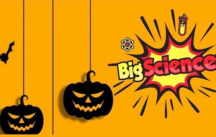 Spooky Halloween cartoon image with black pumpkins, a bat and the wording Big Science