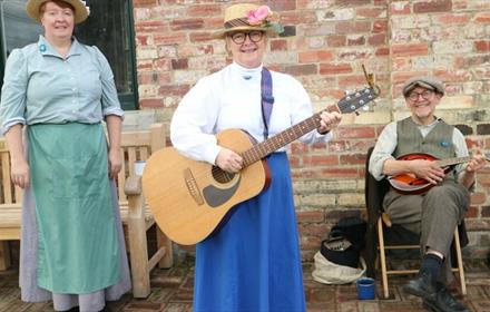 Image of musicians at Beamish Museum, smiling.
