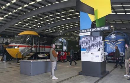 People looking at the exhibition display stand at Locomotion