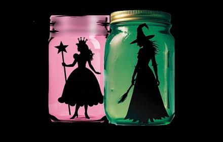 A pink and green lantern containing the silhouettes of Wicked characters