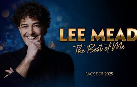 photo of Lee Mead in black against blue background