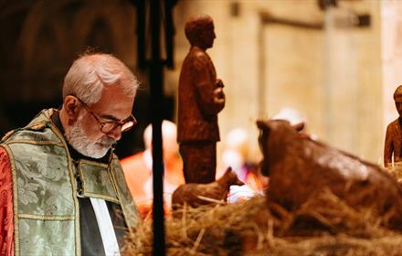 Image of the 'Blessing of The Crib' service at Durham Cathedral - image of the nativity being blessed.