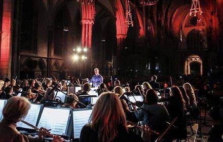 Orchestra playing music in a cathedral