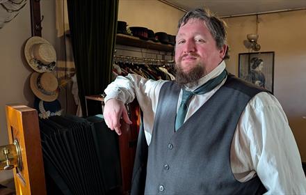 The Beamish Museum photographer standing beside an antique camera