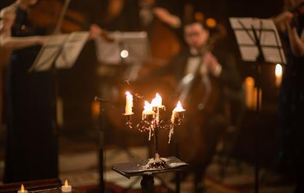 Orchestra playing in candlelight