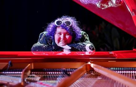 Amity sitting at a piano
