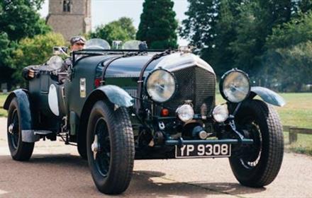 Vintage Sports Car with church in the background