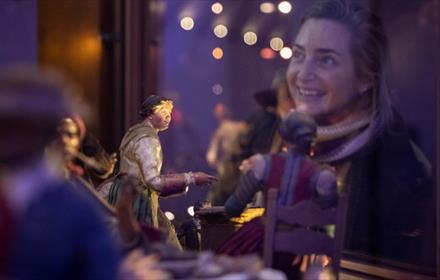 A woman looking at the Neapolitan Nativity scene at The Faith Museum, Auckland Palace