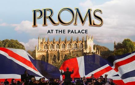 Auckland Palace, an orchestra and conductor and large Union Jack flag