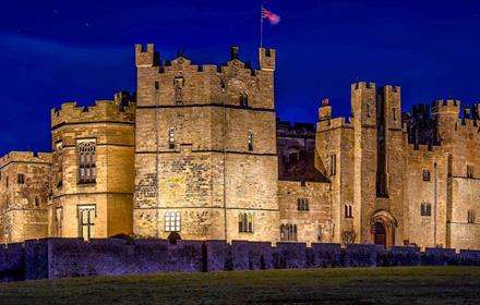 Raby Castle lit up at night time