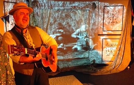 A man playing a guitar.