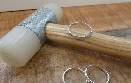 Jewellery hammer and three silver rings