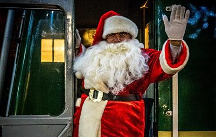 Santa greeting visitors aboard the Santa Express