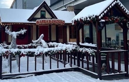 Santa's Grotto covered in snow at Dalton Park