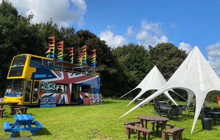Grounds of Ushaw set up with picnic benches and tents in the sunshine