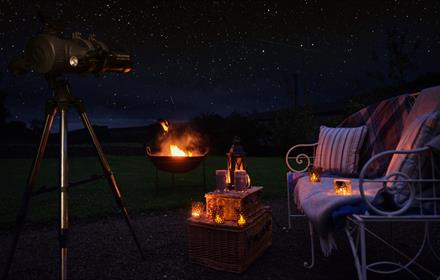 Outdoor seating, fire pit, picnic hamper, a starry dark sky