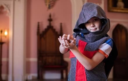 A child in Auckland Castle dressed as a knight