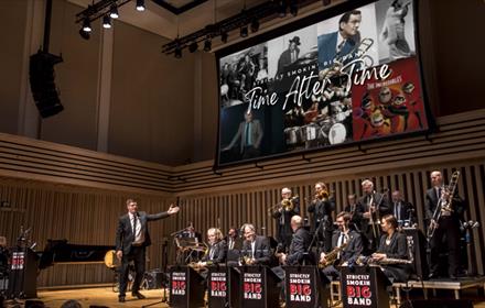 photo of Strictly Smokin' Big Band on stage with screen behind