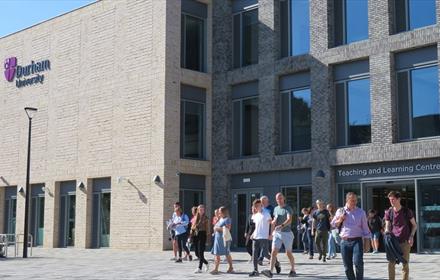 Exterior of Teaching and Learning Centre, people walking out of building.