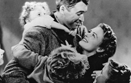It's a Wonderful Life. Black and white poster of a couple being hugged by children.